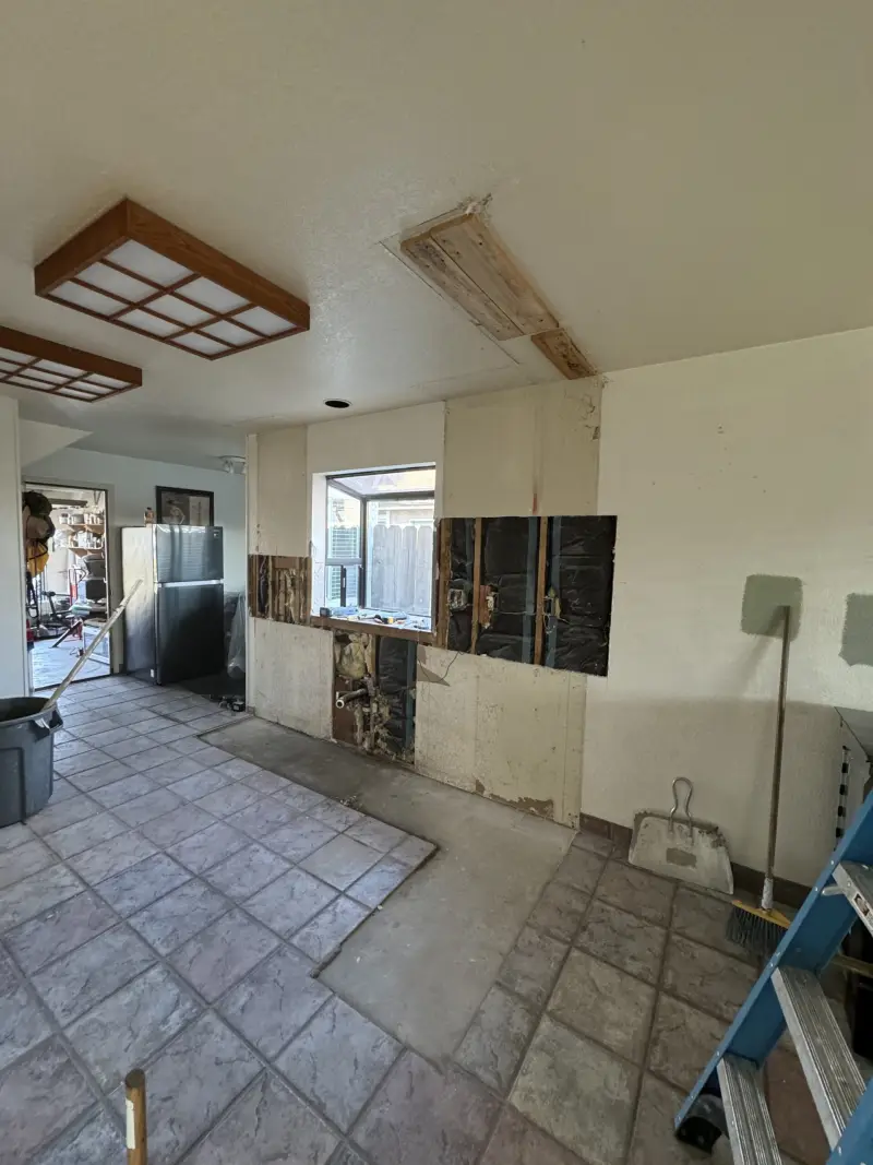 Home remodel during demolition, with walls and cabinets opened up